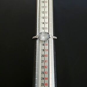 Sterling silver ring with blue center stone and diamond or rhinestones on sides